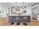 Modern kitchen featuring a large island with seating, stainless steel appliances, and stylish pendant lighting at 10601 Skye Arroyo Ave, Las Vegas, NV 89166