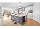 Open-concept kitchen featuring a large island with seating, stainless steel appliances, and ample natural light at 10601 Skye Arroyo Ave, Las Vegas, NV 89166
