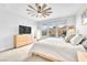 Bedroom with natural lighting, ceiling fan, and backyard swimming pool views at 10601 Skye Arroyo Ave, Las Vegas, NV 89166