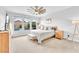 Bright bedroom with multiple windows, ceiling fan, and views of the pool at 10601 Skye Arroyo Ave, Las Vegas, NV 89166