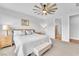 Serene bedroom features modern ceiling fan, neutral tones, and plush carpet at 10601 Skye Arroyo Ave, Las Vegas, NV 89166