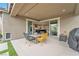 Covered patio with dining table and a view of the kitchen and backyard at 10601 Skye Arroyo Ave, Las Vegas, NV 89166