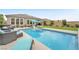 Relaxing pool area featuring lounge chairs and a view of the backyard at 10601 Skye Arroyo Ave, Las Vegas, NV 89166