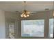 This breakfast nook is bright with natural light and a ceiling fan at 10816 Elm Ridge Ave, Las Vegas, NV 89144