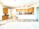 Bright kitchen with wooden cabinets, tile floors, and an island, adjacent to a dining area at 10816 Elm Ridge Ave, Las Vegas, NV 89144