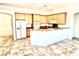 Open-concept kitchen with wooden cabinetry, granite countertops, and a spacious island at 10816 Elm Ridge Ave, Las Vegas, NV 89144