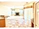Spacious living area with a fireplace, tile flooring, and large windows, offering plenty of light at 10816 Elm Ridge Ave, Las Vegas, NV 89144