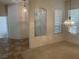 Light-filled living space with modern window treatments and attractive chandelier at 10816 Elm Ridge Ave, Las Vegas, NV 89144