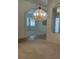 Elegant living space featuring decorative chandelier and arched doorways at 10816 Elm Ridge Ave, Las Vegas, NV 89144