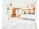 Open-concept living area with modern kitchen featuring stainless steel appliances and adjacent breakfast bar seating at 10816 Elm Ridge Ave, Las Vegas, NV 89144
