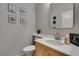 Powder room featuring a light wood vanity, white sink, and decorated walls at 11004 Napa Ridge Dr, Las Vegas, NV 89144