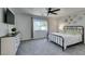 This airy bedroom features a ceiling fan, a dresser and carpet floors, creating a relaxing and comfortable living space at 11004 Napa Ridge Dr, Las Vegas, NV 89144