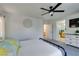 This well-lit bedroom flows into the bathroom and features a ceiling fan and carpet floors at 11004 Napa Ridge Dr, Las Vegas, NV 89144