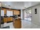 Well lit kitchen with stainless steel appliances, granite counters, kitchen island and light wood cabinets at 11004 Napa Ridge Dr, Las Vegas, NV 89144