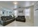 Comfortable living room with tile flooring, a modern fireplace, and a reclining sofa set at 11004 Napa Ridge Dr, Las Vegas, NV 89144