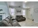 Bright living area with neutral paint, tile flooring, and a cozy reclining sofa set at 11004 Napa Ridge Dr, Las Vegas, NV 89144