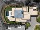 Aerial view of luxury home showcasing its modern architecture, private pool, and landscaped surroundings at 11707 Discovery Canyon Dr, Las Vegas, NV 89135