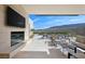 Luxurious backyard featuring a modern fireplace, pool, lounge chairs, and stunning views of the desert landscape at 11707 Discovery Canyon Dr, Las Vegas, NV 89135