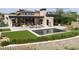 Modern home featuring a rectangular pool, outdoor seating, and an outdoor kitchen perfect for entertaining at 11707 Discovery Canyon Dr, Las Vegas, NV 89135