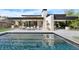 Stunning backyard with a modern pool and patio perfect for entertaining and relaxing under the sun at 11707 Discovery Canyon Dr, Las Vegas, NV 89135