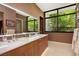 This bathroom boasts a marble countertop, and sinks, wood cabinets, and modern fixtures at 11707 Discovery Canyon Dr, Las Vegas, NV 89135