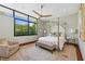 This bright bedroom features floor to ceiling windows, and a unique bed frame at 11707 Discovery Canyon Dr, Las Vegas, NV 89135