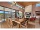 Elegant dining room featuring a long wood table, fireplace, and floor-to-ceiling windows at 11707 Discovery Canyon Dr, Las Vegas, NV 89135