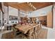 Dining room featuring a large wood table, open layout, fireplace, and access to the kitchen perfect for Gathering meals at 11707 Discovery Canyon Dr, Las Vegas, NV 89135