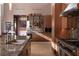 Gourmet kitchen with stainless steel appliances, granite countertops, and a breakfast bar at 11707 Discovery Canyon Dr, Las Vegas, NV 89135