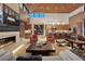 Modern living room features hardwood floors, fireplace, and windows that let in lots of natural light at 11707 Discovery Canyon Dr, Las Vegas, NV 89135