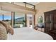 This main bedroom boasts floor to ceiling windows with clerestory and an exterior view at 11707 Discovery Canyon Dr, Las Vegas, NV 89135