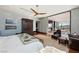 Bright main bedroom features wood floors, a ceiling fan, an area rug and access to a patio at 11707 Discovery Canyon Dr, Las Vegas, NV 89135