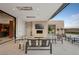Elegant outdoor space with comfortable seating, sleek fireplace, and seamless access to the indoors at 11707 Discovery Canyon Dr, Las Vegas, NV 89135