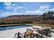 Relaxing pool area featuring a stunning mountain view and comfortable lounge chairs at 11707 Discovery Canyon Dr, Las Vegas, NV 89135