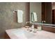 The powder room features a marble countertop, stainless fixtures, and modern finishes at 11707 Discovery Canyon Dr, Las Vegas, NV 89135