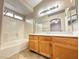 Well-maintained bathroom with a large vanity, mirror, and a shower-tub combo at 1201 Dusty Creek St, Las Vegas, NV 89128