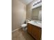 This half bath includes a single sink vanity and a neutral color palette at 1201 Dusty Creek St, Las Vegas, NV 89128