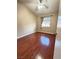 This bright bedroom features hardwood floors, window with blinds, and a ceiling fan at 1201 Dusty Creek St, Las Vegas, NV 89128