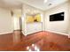 Open living room featuring hardwood floors, large tv, and seamless flow to the kitchen at 1201 Dusty Creek St, Las Vegas, NV 89128