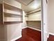 Walk-in closet featuring built in shelving and laminate flooring at 1201 Dusty Creek St, Las Vegas, NV 89128