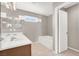 Bright bathroom showcasing double sinks, a soaking tub and a window for natural light at 176 Jay Porter Ave, Henderson, NV 89002