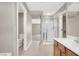Hall bathroom featuring tile floors, vanity, glass shower, and access to other rooms at 176 Jay Porter Ave, Henderson, NV 89002