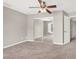 Bedroom with ceiling fan, neutral paint, plush carpet, large mirrored closet, and open doorway at 176 Jay Porter Ave, Henderson, NV 89002