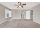 Bright bedroom with neutral colored walls and carpet, ceiling fan, and window letting in natural light at 176 Jay Porter Ave, Henderson, NV 89002
