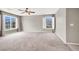 Open bedroom with carpet, neutral walls, ceiling fan and a large window view at 176 Jay Porter Ave, Henderson, NV 89002