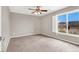 Bedroom featuring ceiling fan, neutral walls, carpeted floors and window shutters overlooking nearby homes at 176 Jay Porter Ave, Henderson, NV 89002