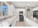 Well-lit kitchen showcases stainless steel appliances, shaker cabinets, and a cozy breakfast nook at 176 Jay Porter Ave, Henderson, NV 89002