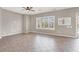 Large living room features tile floors, a window with shutters, and backyard access at 176 Jay Porter Ave, Henderson, NV 89002