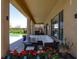 Inviting covered patio featuring comfortable seating, outdoor dining, and a view of the backyard and pool at 176 Jay Porter Ave, Henderson, NV 89002