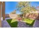Beautiful backyard with stone pavers, artificial grass, and decorative rock feature at 1794 Morro Vista Dr, Las Vegas, NV 89135